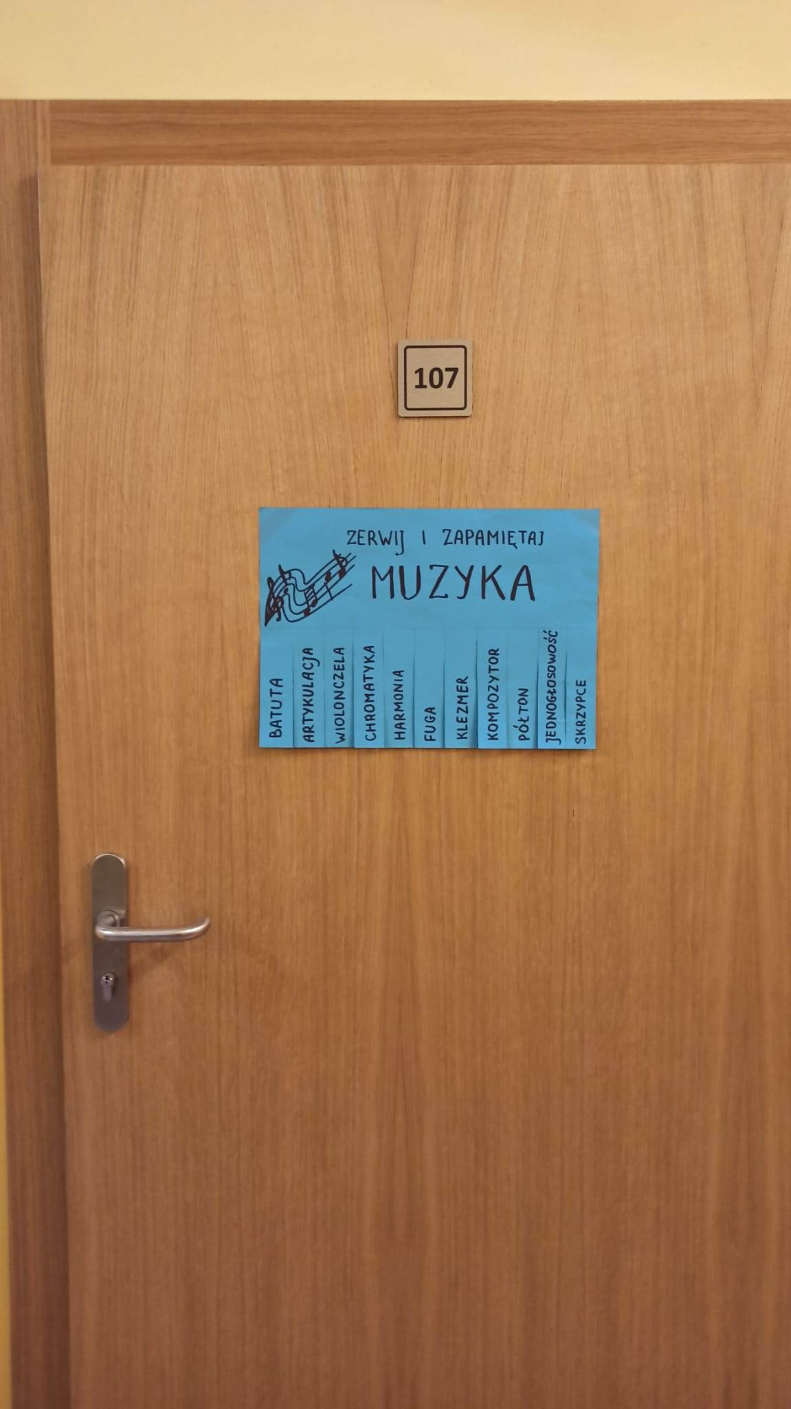 Zdjęcie przedstawia ogłoszenia wiszące na drzwiach sali z muzyki.
