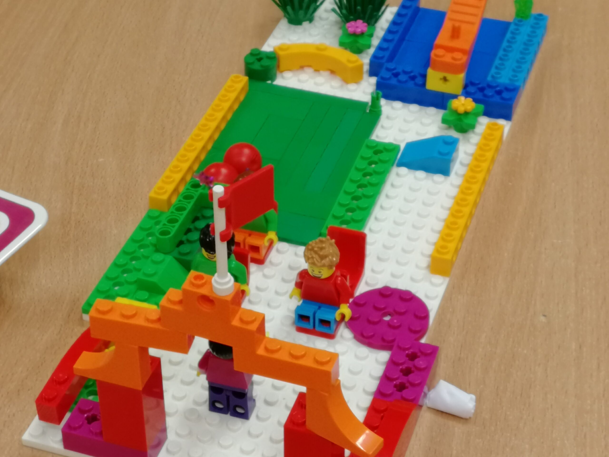 Uczniowie klasy 5b projektują szkołę marzeń z wykorzystaniem klocków lego.